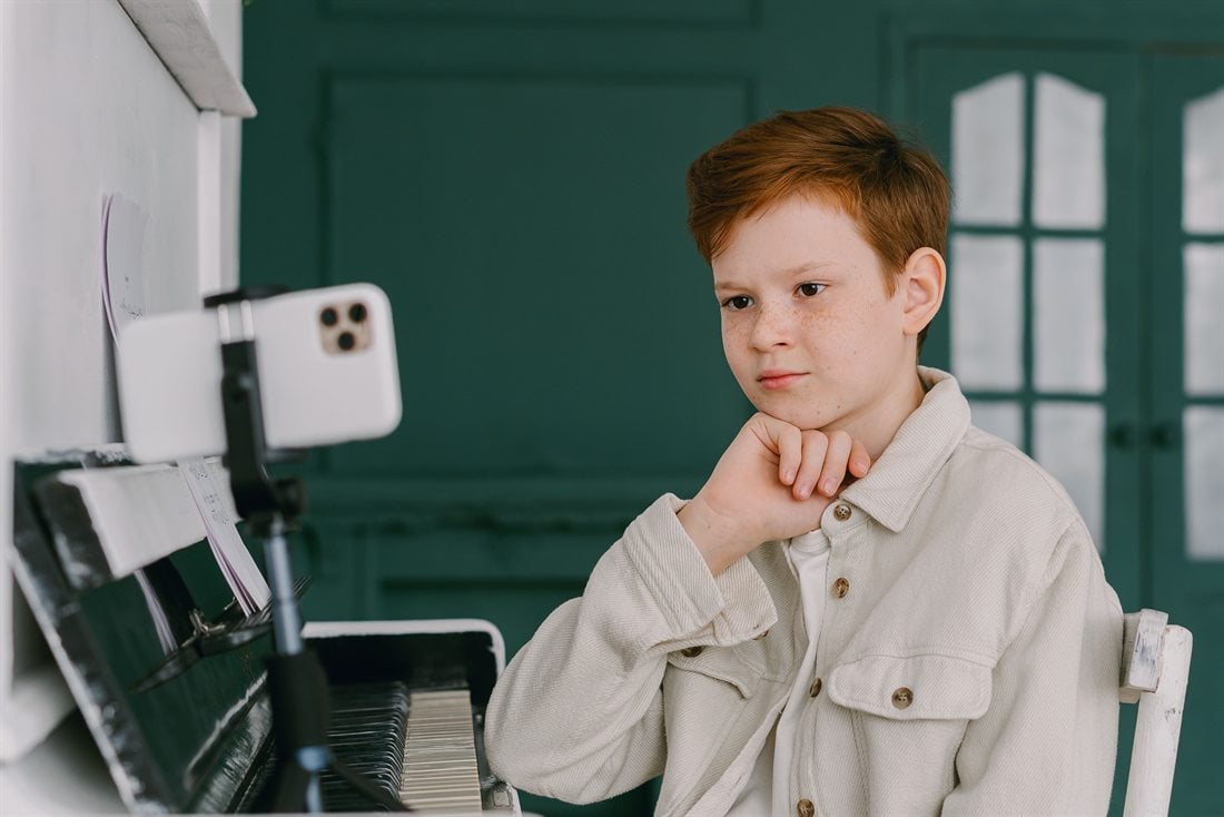 Student taking an online piano lesson