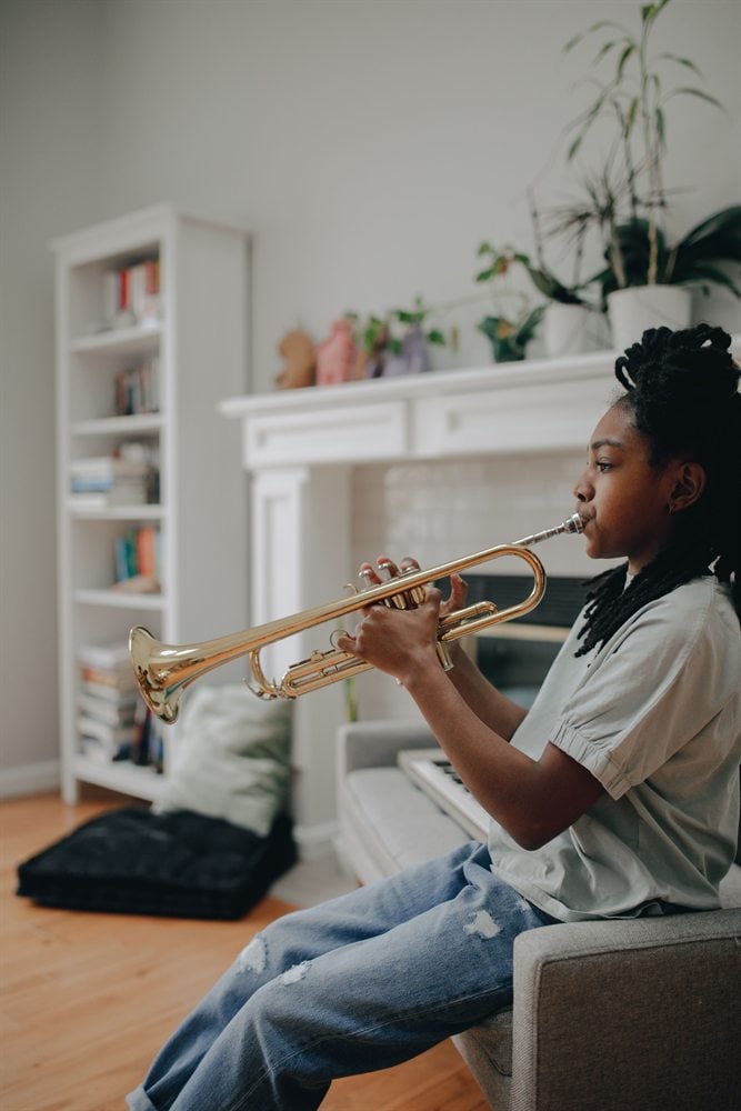 Student practicing trumpet at home