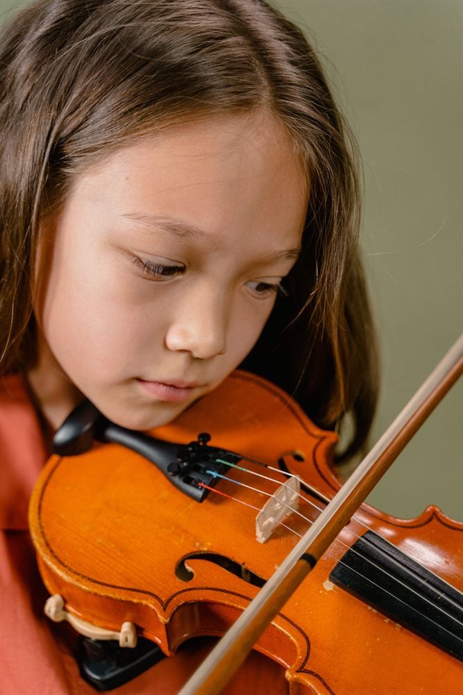 Student concentrating while playing violin